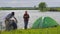 Family near the lake, tent, folding table