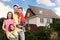 Family near their house with solar panels. Alternative energy source