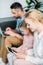 family with one child using gadgets while sitting together