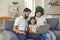 Family online laptop. Happy family uses laptop video call while sitting on sofa at home.