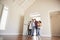 Family Opening Door And Walking In Empty Lounge Of New Home