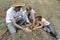 Family of organic farmers planting seedling