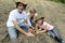 Family of organic farmers planting seedling