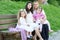 Family on outdoor, pregnant woman with child and man, city park, summer season, green grass and trees