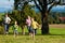 Family outdoors is running on a meadow