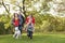 Family Outdoors Walking Through Park