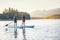 Family Paddleboarding together on a Beautiful Mountain Lake