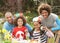 Family Painting Easter Eggs In Gardens