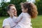 Family, parenthood, fatherhood and people concept - happy man and little girl in having fun in summer park. Cute curly girl