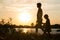 Family of parents and children silhouettes at sunset