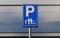 Family parking sign on gray background. Reserved parking for parents with children