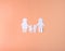 Family on a peach background made of white paper. Mom Dad Daughter and Son. There is a place for inscription. The idea of ??