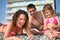 Family on pebble in swimwear