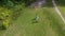 Family people parents and children walking on park meadow. Aerial shot