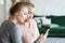 Family, people and technology. Aged woman and her adult daughter using smartphone at home.