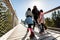 Family people walking wooden treetop bridge canopy walkway in winter