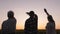 Family People Wave Goodbye To Sun At Sunset In Rural Field