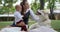 Family and pet, little boy in suit on hands of mother stroking the husky on green grass in a park