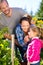 Family picking berries in garden