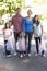 Family Picking Up Litter In Suburban Street