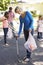 Family Picking Up Litter In Suburban Street