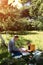 Family picnic. Dad and son in a green garden in sunny weather on a picnic eating pizza