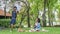 Family Picnic at garden park Outdoors Together Relaxation Concept with kid rides on the father`s neck