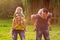 Family piggyback their children and have fun together in park