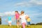 Family in playful mode on a meadow in summer