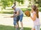 Family playing baseball in the park