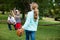 Family playing baseball in the park