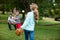 Family playing baseball in the park