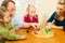 Family playing a board game