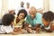 Family Playing Board Game At Home