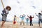 Family playing cricket on beach