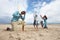 Family playing cricket on beach