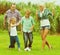 Family playing football on field