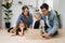 Family playing muscle control and logic game, building things with wooden blocks