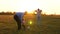 Family playing with younger baby with soccer ball in the park at sunset. Happy dad and child kick ball. happy family