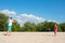 Family plays badminton at the beach on a Sunny warm summer day. The concept of sport and active play summer lifestyle