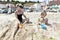 A family plays on the sand, the shore of the Black Sea.