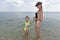 A family plays on the sand, the shore of the Black Sea.