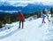 Family plays at snowballs on winter mountain slope