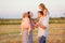 Family plays at sunset on field countryside