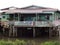 A family on the porch of a house in Kampong Ayer floating village in Brunei