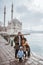 family portrait in front of beautiful ortakoy mosque