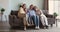 Family portrait happy 4 diverse female generations hug on couch