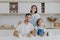 Family portrait of happy mother, daughter and father pose at kitchen during breakfast time, eat delicious homemade pancakes, their