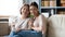 Family portrait older mother and adult daughter sitting on couch