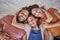 Family, portrait and relax in bed by girl and parents resting from above, happy and smile in home together. Happy family